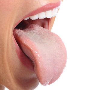 Nahaufnahme des Mundes einer Frau, die ihre Zunge isoliert auf einen weißen Hintergrund klebt